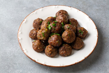 Round shaped balls of dry meatballs and french fries. Turkish name; kuru kofte ve patates