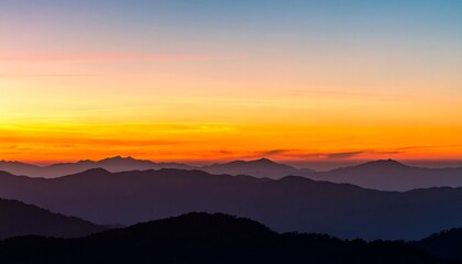 Obraz premium Sunrise over blurred mountain ranges