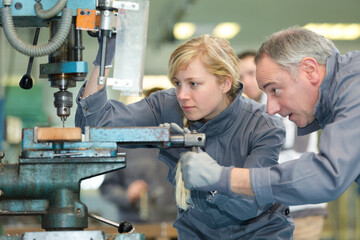 man and woman apprentice at a factory