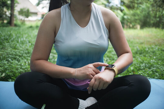 Closeup hand of female athletes using smart watch during her yoga training