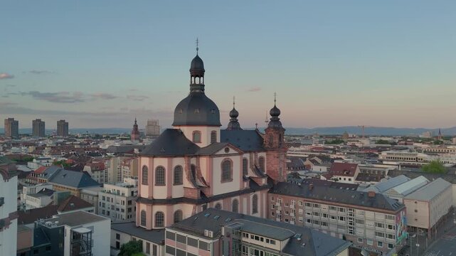 Aerial drone footage of Mannheim and Christuskirche on summer evening, showcasing German architecture. Mannheim, Germany