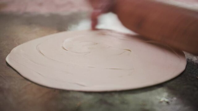 Freshly made Indian roti, chapati, or paratha being cooked at a local street food stall in Mumbai city