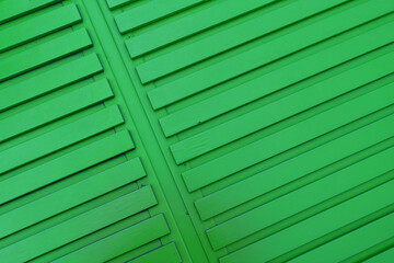 Bright green diagonal striped wooden background, designer backdrop. Copy space