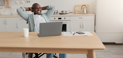 Great job, successful business, rest, relax on break at home. Happy adult african american guy disabled in wheelchair put hands behind head in kitchen with laptop at workplace looks at free space