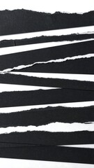 Torn black paper strips on white