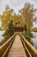 Obraz premium Wooden Path to Autumn Island Cabin