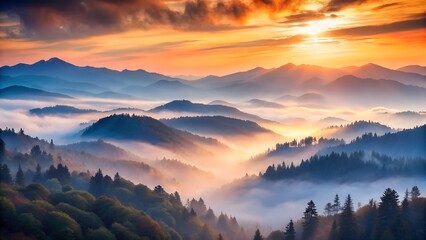 Obraz premium Misty mountain range at sunrise with golden light breaking through the clouds