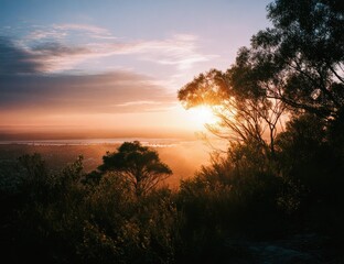 Fototapeta premium Sunrise over a city landscape from a hilltop