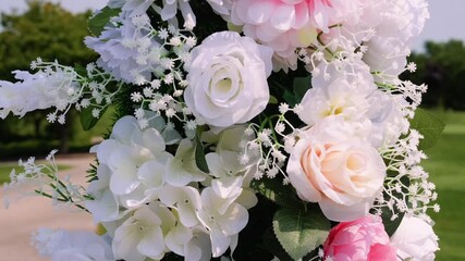 white and pink flowers on an arch