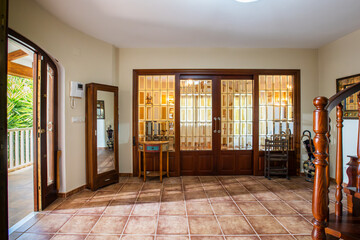 The entrance hall of a wealthy house with furniture