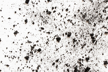 Scattered coal crumbs and dust on white background as texture