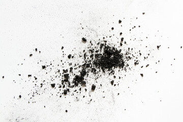 Fototapeta premium Scattered coal crumbs and dust on white background as texture