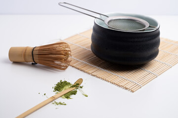 Green matcha close-up. Chasen, bamboo whisk. Traditional tools for making matcha. Matcha powder....