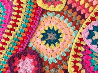 brown hands crocheting colorful yarn. multicolor yarn wool textured pattern for crochet. crochet...