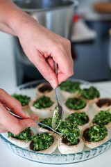 Naklejka na ściany i meble Stuffed mushrooms are prepared with spinach filling
