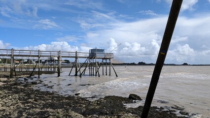 Rustic wooden fishing hut on stilts in the tidal waters of the French Atlantic coast