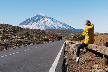 Woman enjoying the view of Teide volcano, El Teide National Park, Tenerife, Canary Islands, Spain.
