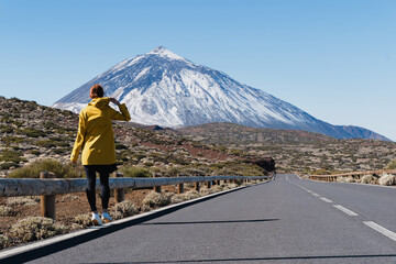 Woman enjoying the view of Teide volcano, El Teide National Park, Tenerife, Canary Islands, Spain.