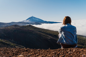 Tourist admiring breathtaking view of volcano Teide. Tenerife, Canary Islands, Spain.