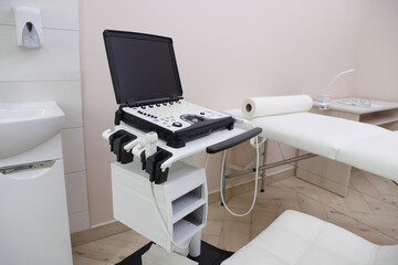 Modern ultrasound machine and examination bed in clinic