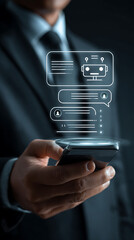 Man in suit holding phone displaying AI chatbot conversation with user icons artificial intelligence