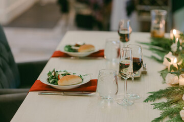 Elegant dinner setting for a celebration with gourmet food and wine at a beautifully arranged table