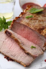 Delicious baked beef meat and spices on table, closeup