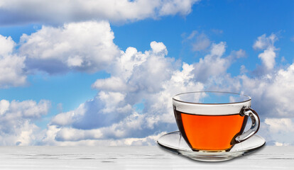 tea in a glass cup against a blue sky
