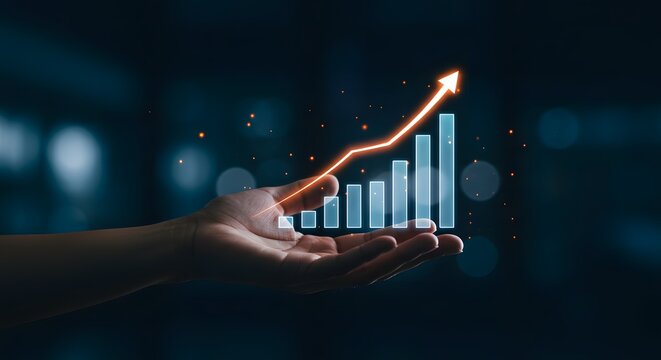 Hand holding glowing upward trending business graph with arrow