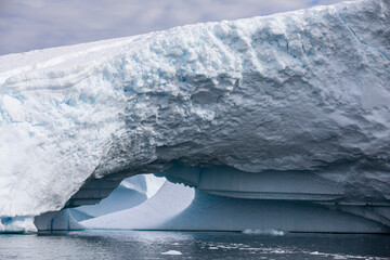 large iceberg with arch opening near Yalour Islands Antarctica