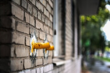 Severed gas supply pipes leading to a residential building, cut off from the street side