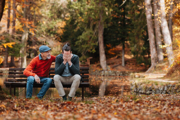 Older father comforting upset son.