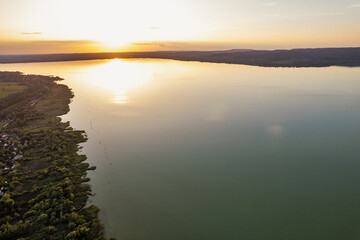 Spectacular sunset over lake Balaton with golden reflections, Hungary.