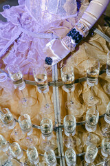 Elegant dress adorned with glasses showcasing a creative display of beverages at a formal event during the evening