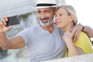 senior couple taking selfie