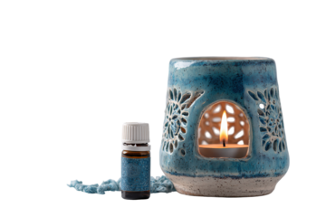 Blue ceramic aromatherapy burner with essential oil bottle.