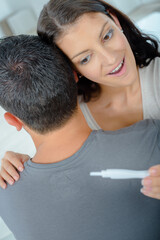 happy couple holding a test is positive pregnancy