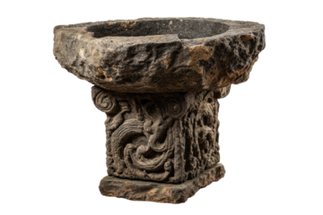 Ancient weathered stone baptismal font with ornate carvings isolated.