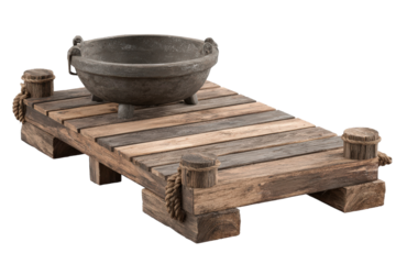 Rustic wooden platform with an antique cast iron cauldron.