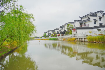 Obraz premium Nantong, Jiangsu, China: 04 21 2025: Beautiful Jiangsu Nantong traditional Chinese building, Roof, wall, tile and door