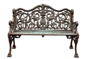 Ornate vintage cast iron garden bench isolated on white background.