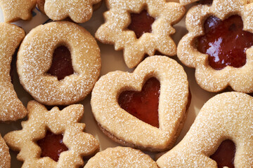 Closeup of homemade Linzer Christmas cookies filled with marmalade and dusted with sugar