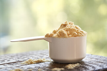 Whey protein powder in a measuring cup