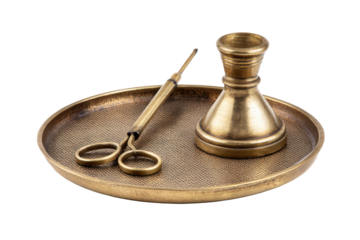 Vintage brass candle care set with snuffer and wick trimmer on a tray.