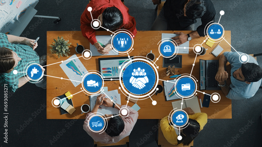 Poster this overhead image captures a collaborative business meeting with diverse professionals, highlighti