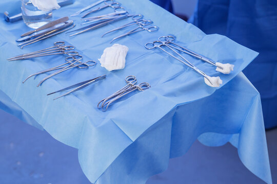 Sterile surgical tools arranged on blue drape before procedure in operating room
