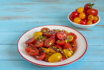 Cherry tomato salad in ceramic plate.