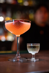 Pornstar Martini cocktail on a bar counter with beautiful bokeh in the background