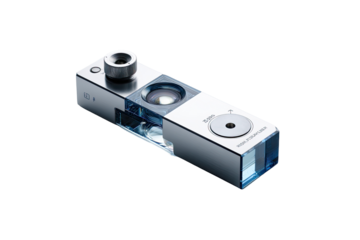 Metallic rectangular device with transparent elements, likely a scientific instrument. Clear components, possibly optical, within. Rounded ends, small circular aperture on one side