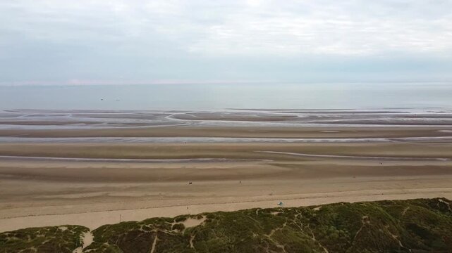 Scenery flight over Formby beach at low tide near Liverpool, England